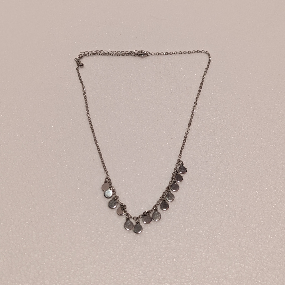 Necklace with small silver tone adornments